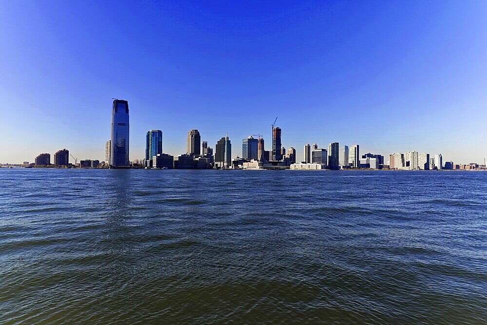 Panoramic view of the skyline of a big city on the water on a clear day, Manhattan, Down Town, New York City, New York, USA, North America, Wide panorama of the skyline with skyscrapers, water in the foreground