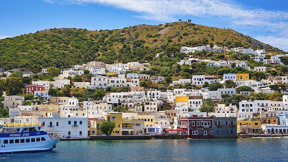 Colourful houses on a green hill, right by the sea, radiant atmosphere, Lakki, Leros, Dodecanese, Greek Islands, Greece