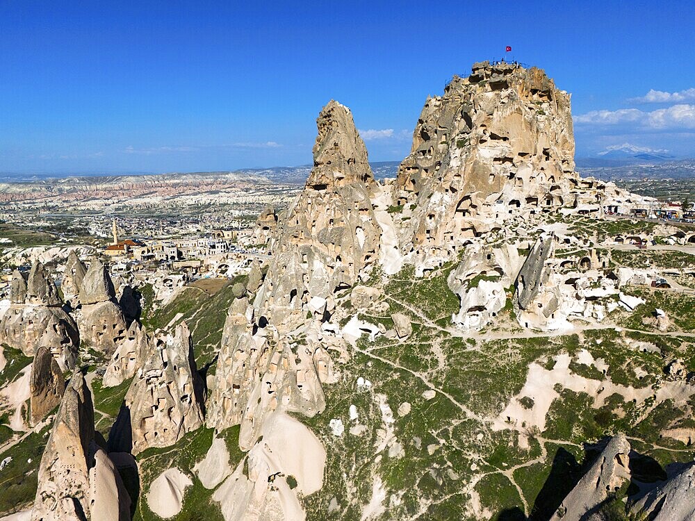 Rocky landscape with ancient rock structures under a clear blue sky in Cappadocia, aerial view, Uchisar Castle, Uçhisar Kalesi, impressive rock formation and fortress, Göreme National Park, Göreme Tarihî Millî, Nevsehir Province, Nevşehir, Cappadocia, Cappadocia, Kapadokya, Cappadocia, Central Anatolia, Turkey
