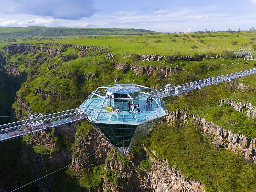 A glass platform with people stands on a bridge overlooking a green gorge, surrounded by picturesque nature, Diamond Bridge, Diamond Glass Bridge, world's longest free-hanging structure, Dashbashi Gorge, Khrami River, Tsalka Nature Reserve, Kartlia, Georgia