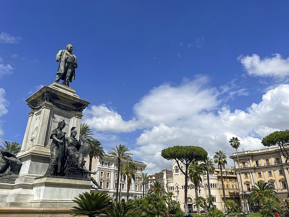 Impressive monument with statues in front of classical architecture and blue sky, Rome, Italy