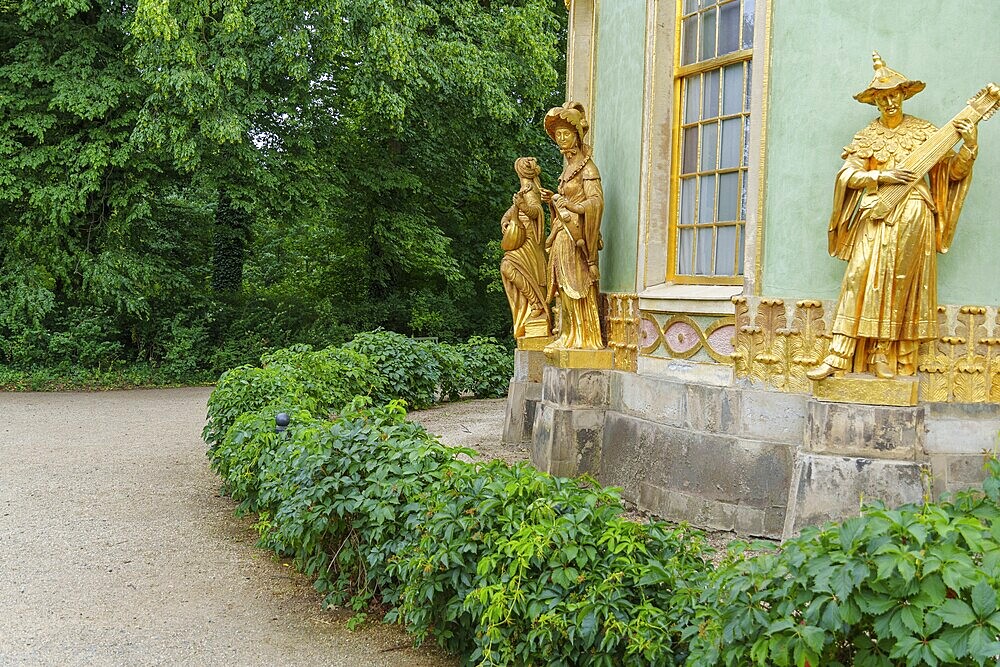 Golden baroque sculptures adorn a pavilion on the garden path, potsdam, brandenburg, germany