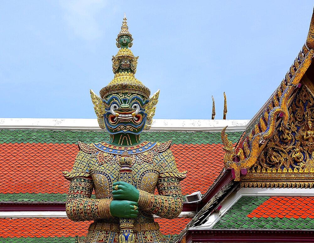 Colorful giant yaksha statue guarding the entrance of wat phra kaew, temple of the emerald buddha, grand palace, bangkok, thailand