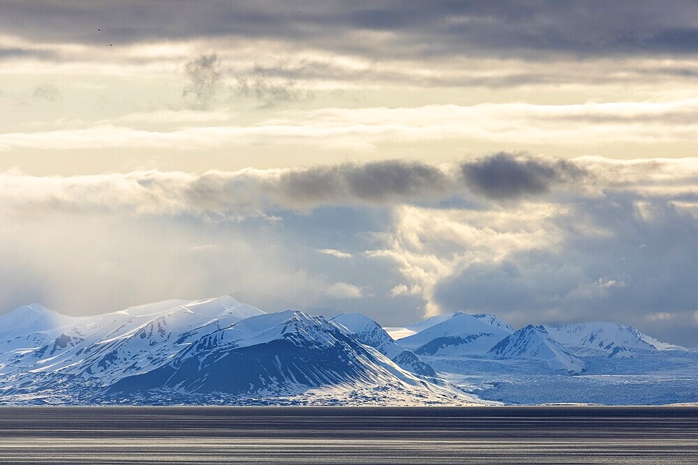Snow-covered mountains by the sea, clouds, Longyearbyen, Spitsbergen, Svalbard