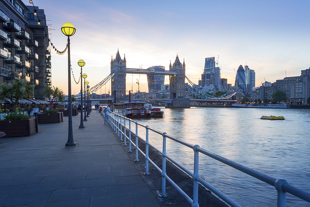 Tower Bridge and City of London skyline from Butler's Wharf at sunset, London, England, United Kingdom, Europe