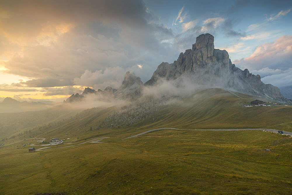 View of landscape and winding road from Marmolada Pass at sunset, South Tyrol, Italian Dolomites, Italy, Europe