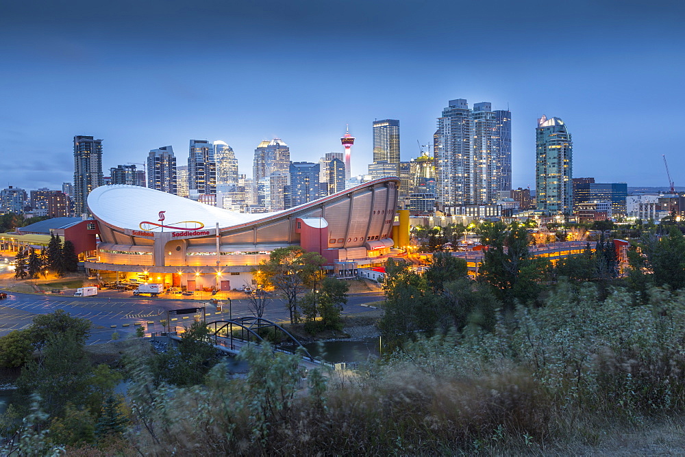 View of the Saddledome and Downtown skyline from Scottsman Hill at dusk, Calgary, Alberta, Canada, North America