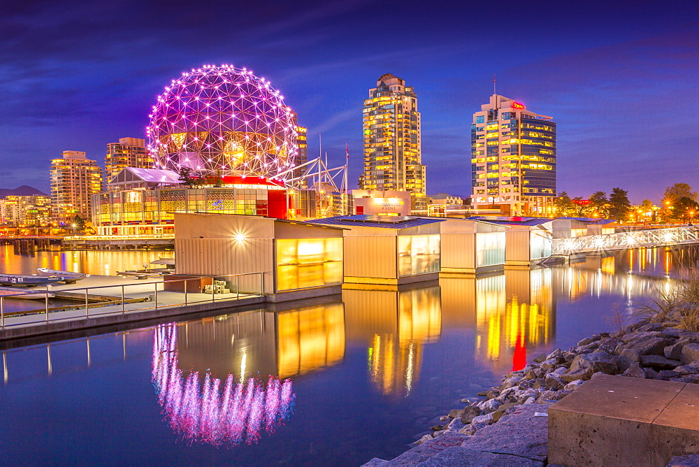 View of False Creek and Vancouver skyline, including World of Science Dome at dusk, Vancouver, British Columbia, Canada, North America