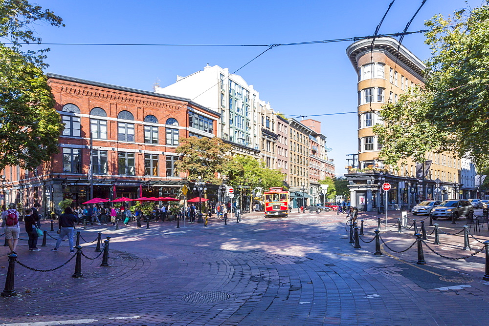 Architecture, trolleybus and cafe bar in Maple Tree Square in Gastown, Vancouver, British Columbia, Canada, North America