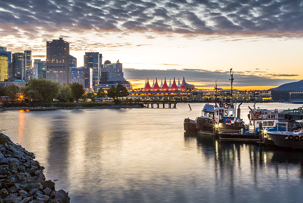 View of Canada Place and urban office buildings at sunset from CRAB Park, Vancouver, British Columbia, Canada, North America