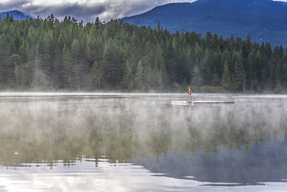 Mist on Lost Lake, Ski Hill and surrounding forest, Whistler, British Columbia, Canada, North America