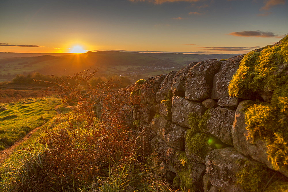 View of sunset from dry stone wall on Baslow Edge, Baslow, Peak District National Park, Derbyshire, England, United Kingdom, Europe