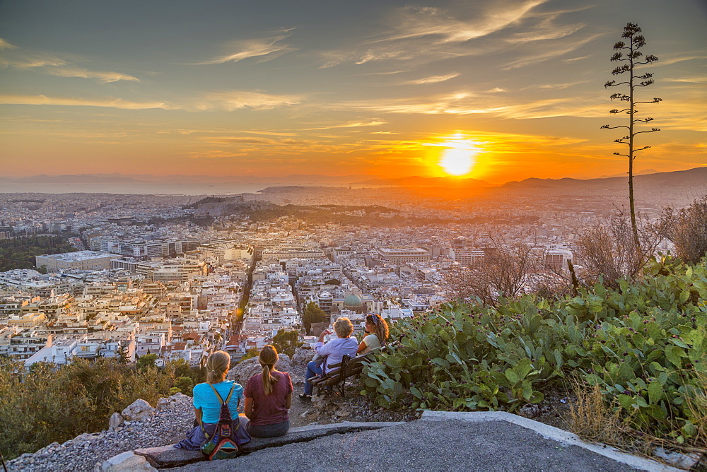 People watching sunset over Athens from Likavitos Hill, Athens, Greece, Europe