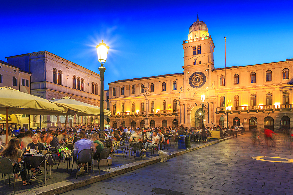 View of cafes and Torre Dell'Orologio in Piazza dei Signori at dusk, Padua, Veneto, Italy, Europe