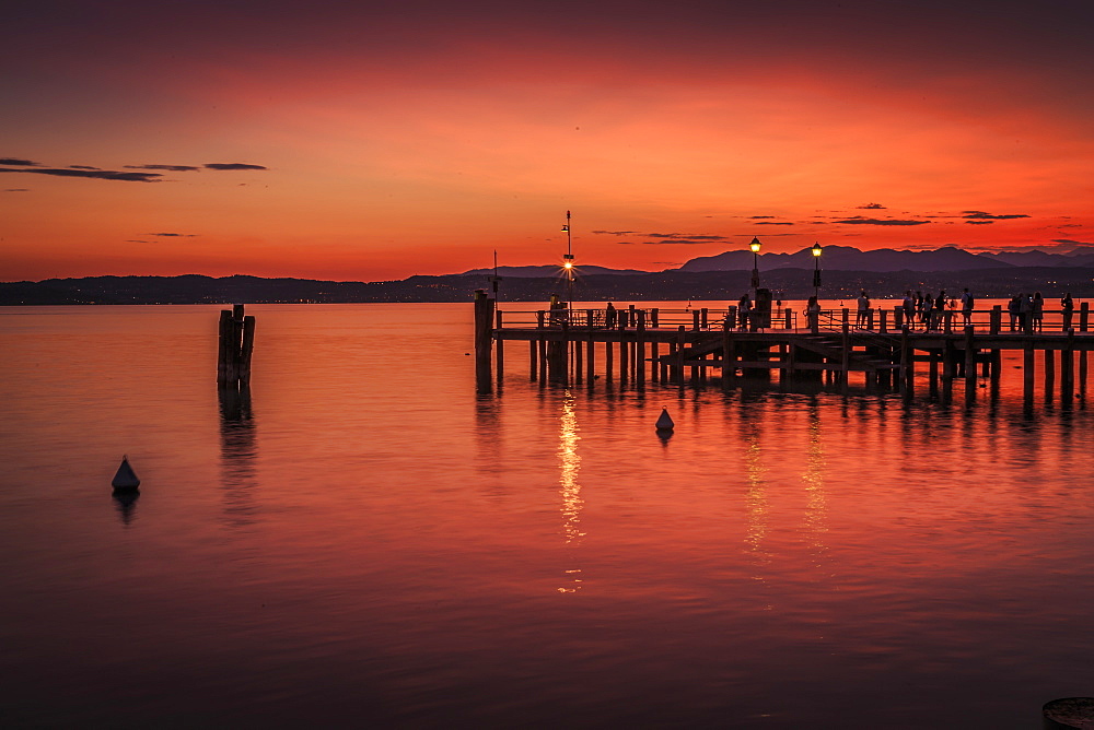 View of golden sunset on Lake Garda, Sirmione, Lake Garda, Lombardy, Italian Lakes, Italy, Europe