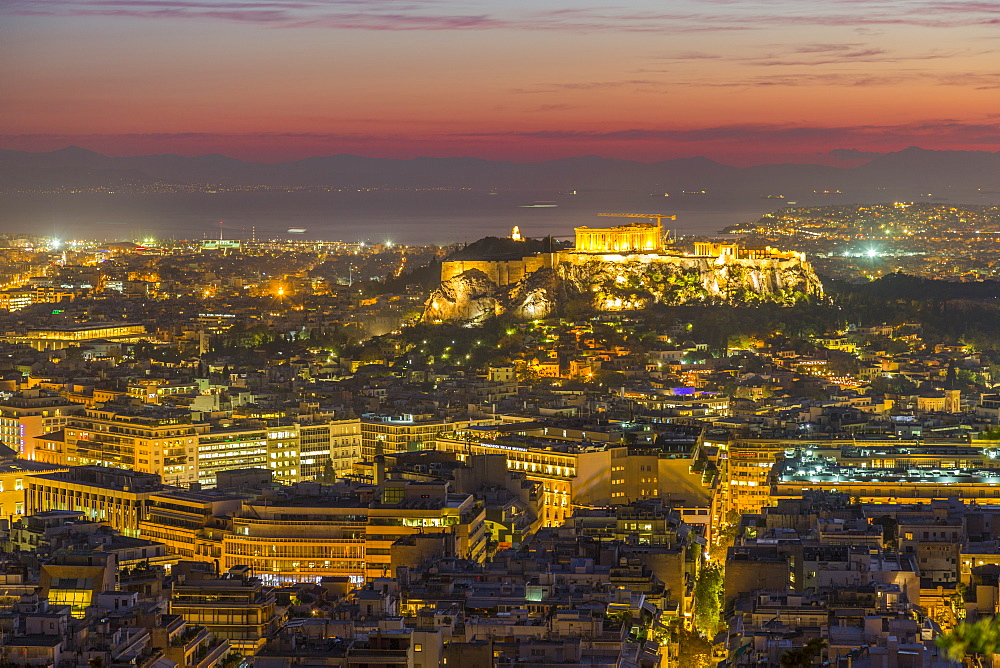 View of Athens and The Acropolis from Likavitos Hill with the Aegean Sea visible on horizon at dusk, Athens, Greece, Europe