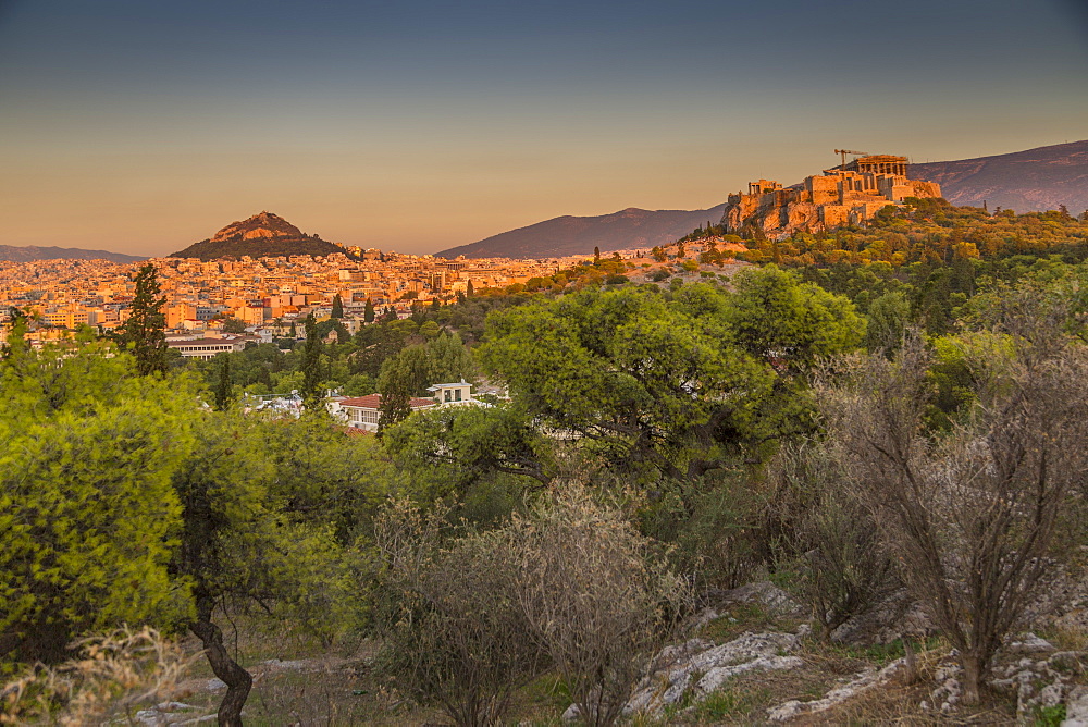 View of The Acropolis and Likavitos Hill at sunset from Filopappou Hill, Athens, Greece, Europe