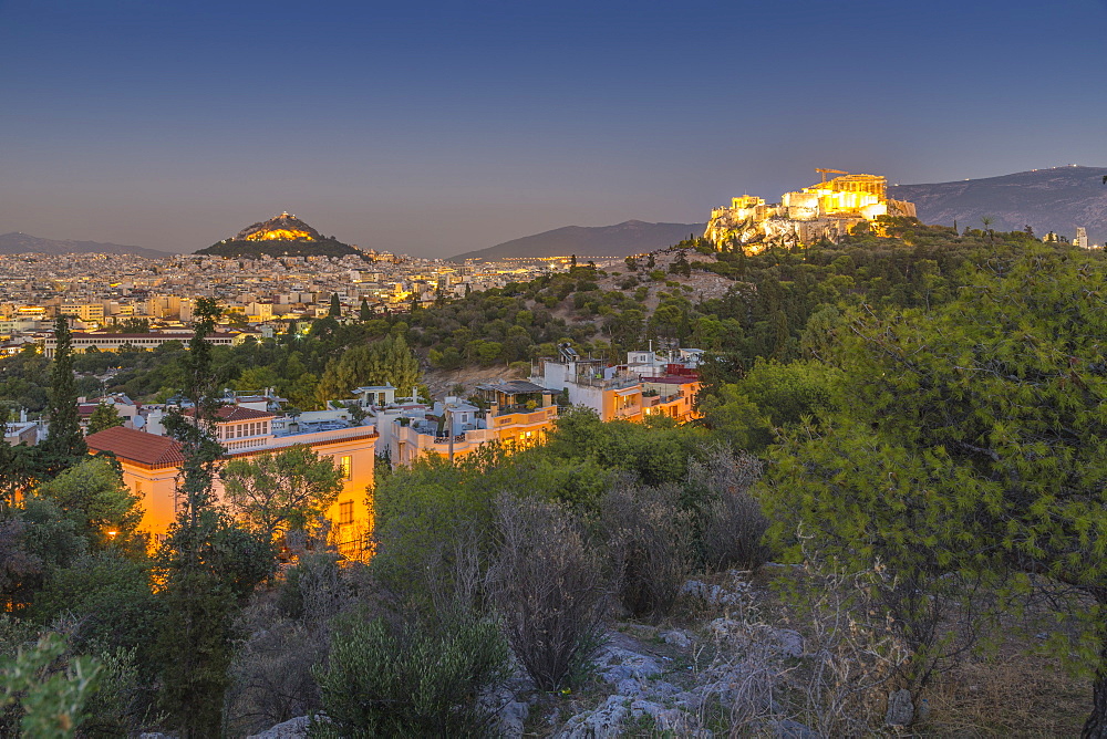 View of The Acropolis and Likavitos Hill at dusk from Filopappou Hill, Athens, Greece, Europe