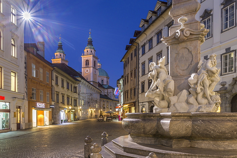 View of Cathedral of St. Nicholas and Robba fountain at dusk, Ljubljana, Slovenia, Europe