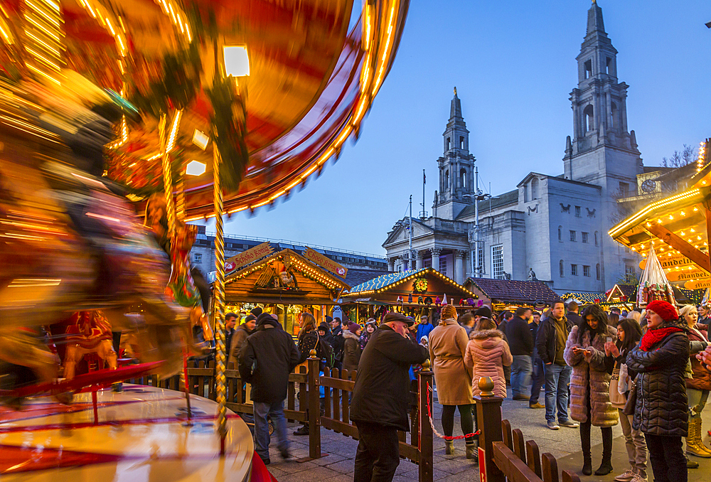 View of carousel and Christmas Market stalls at Christmas Market, Millennium Square, Leeds, Yorkshire, England, United Kingdom, Europe