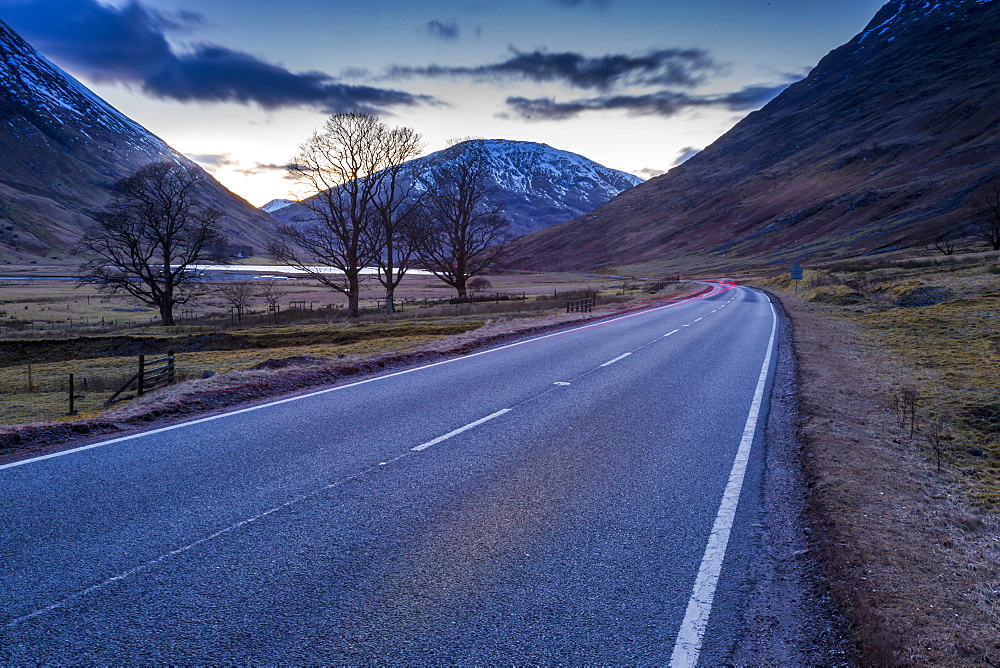 View of road through the Glencoe Valley at dusk, Glencoe, Highland Region, Scotland, United Kingdom, Europe