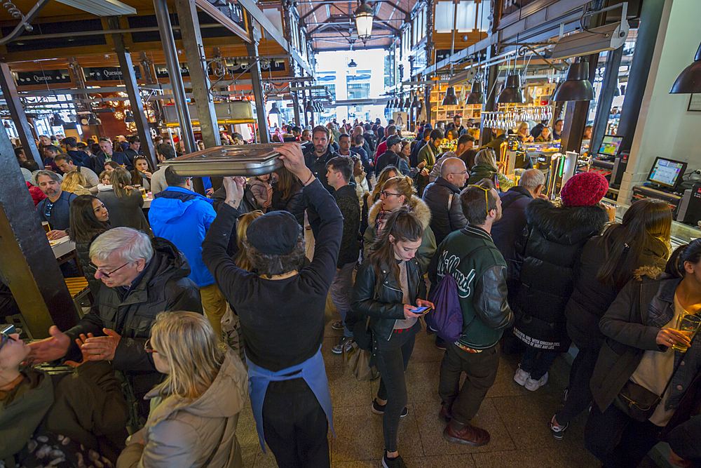 Hustle and bustle of the interior of San Miguel Market, Madrid, Spain, Europe