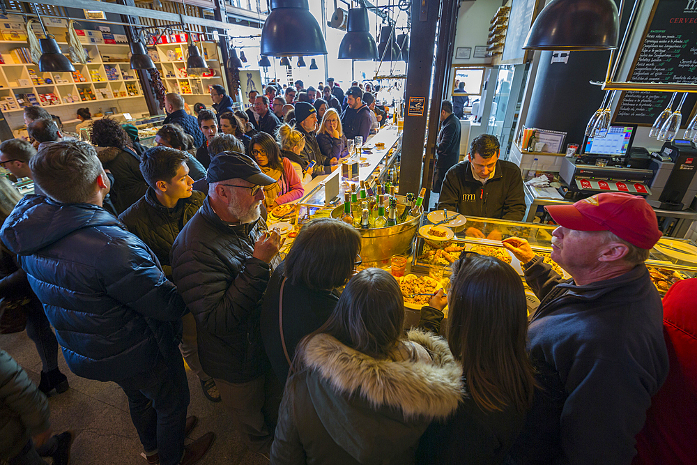 Hustle and bustle of the interior of San Miguel Market, Madrid, Spain, Europe