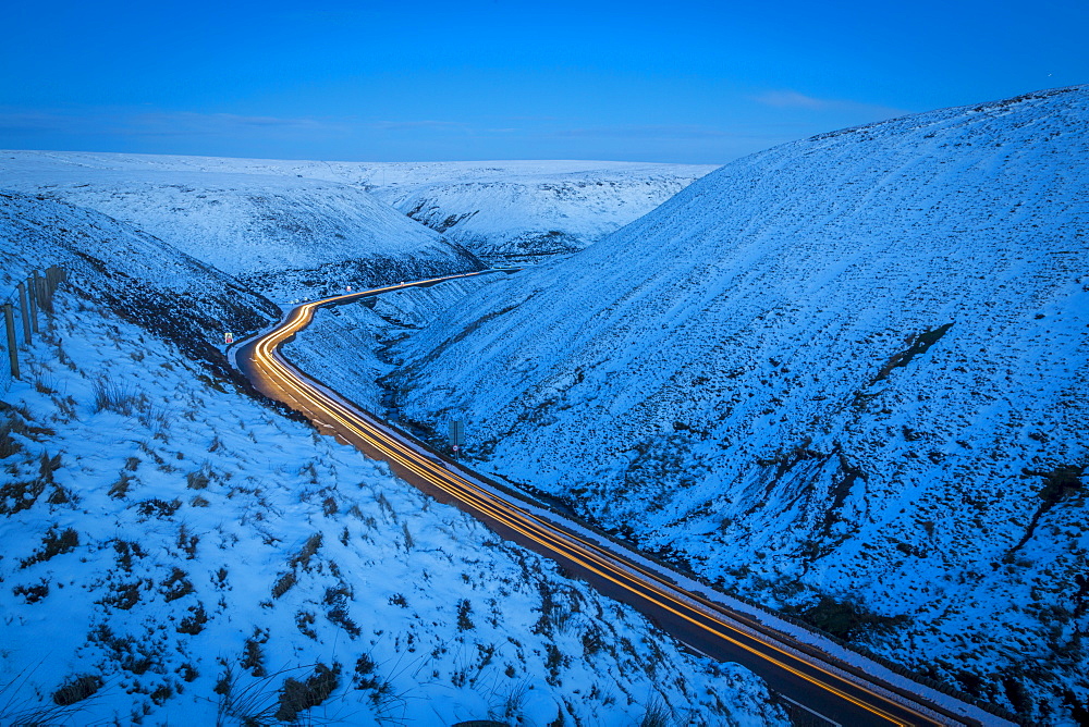 Winter landscape and trail lights on Snake Pass, Peak District National Park, Derbyshire, England, United Kingdom, Europe