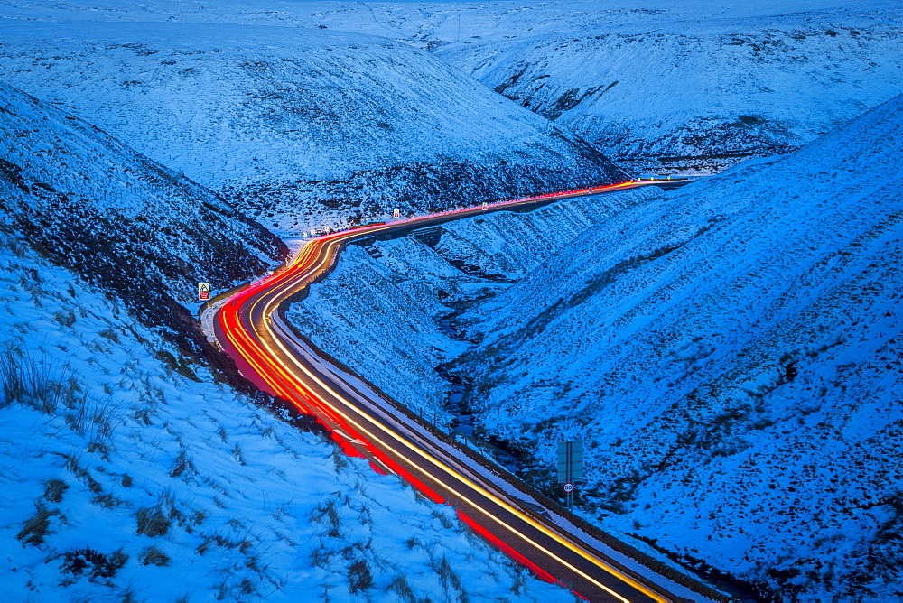 Winter landscape and trail lights on Snake Pass, Peak District National Park, Derbyshire, England, United Kingdom, Europe