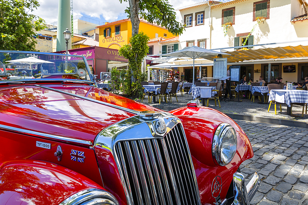 View of red vintage MG car in front of traditional Al Fresco restaurant in old town, Funchal, Madeira, Portugal, Europe