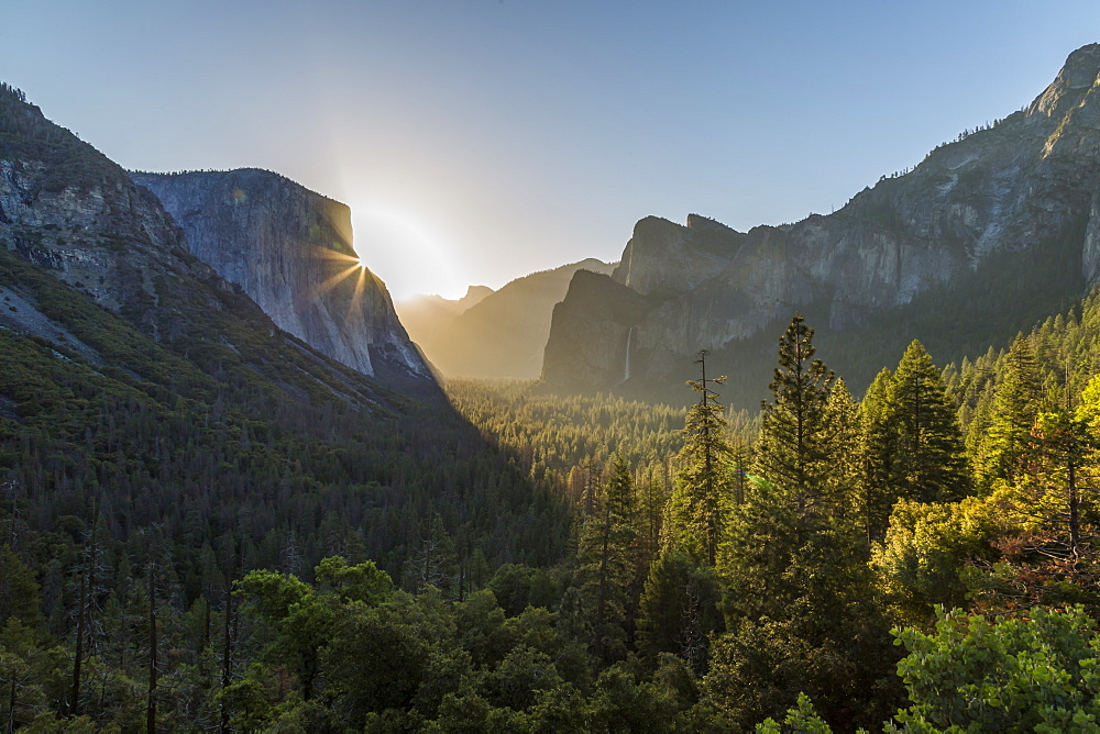 Morning view of sun peaking round El Capitan, Yosemite National Park, UNESCO World Heritage Site, California, United States of America, North America