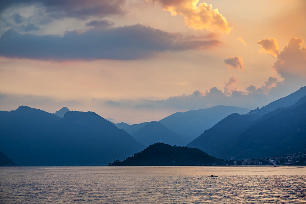 View of solitary rowing boat on Lake Como at sunset, Province of Como, Lake Como, Lombardy, Italian Lakes, Italy, Europe