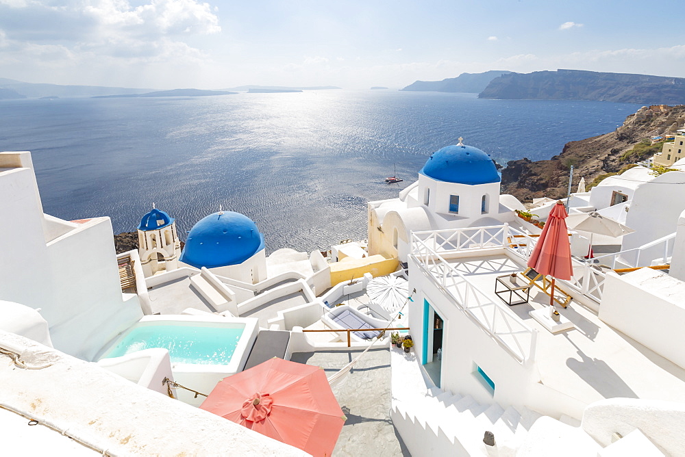 View of blue domed churches from cafe in Oia village, Santorini, Cyclades, Aegean Islands, Greek Islands, Greece, Europe