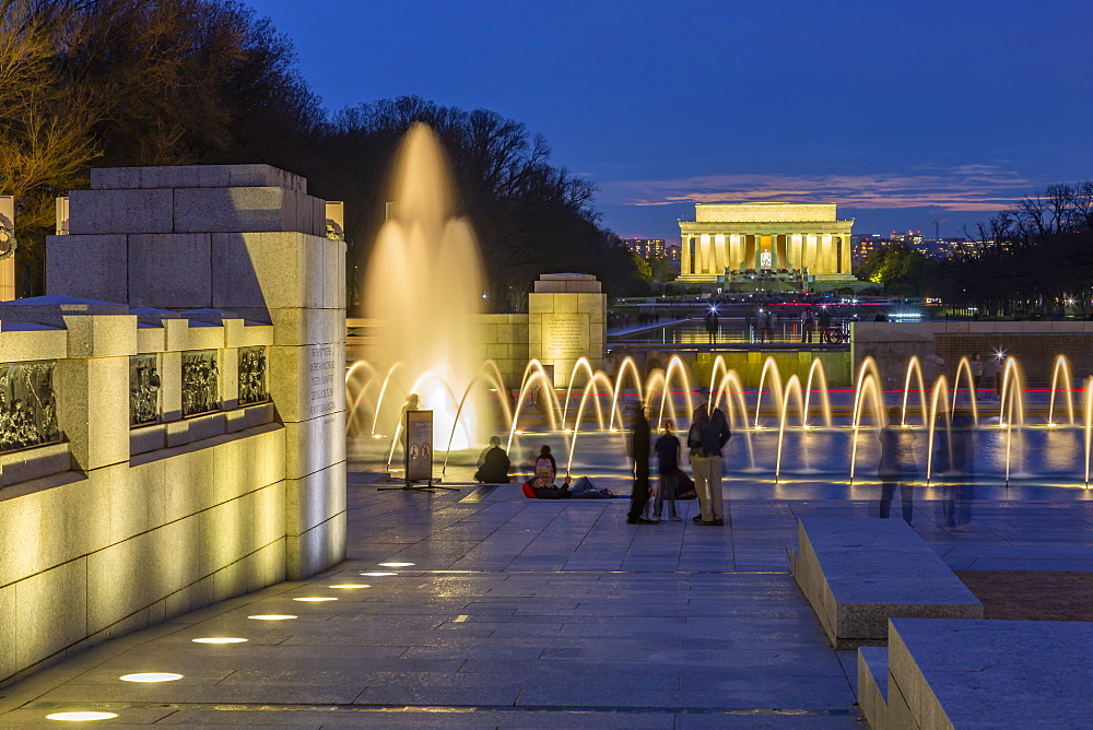 View of the World War Two Memorial and Lincoln Memorial illuminated at dusk, Washington, D.C., United States of America, North America