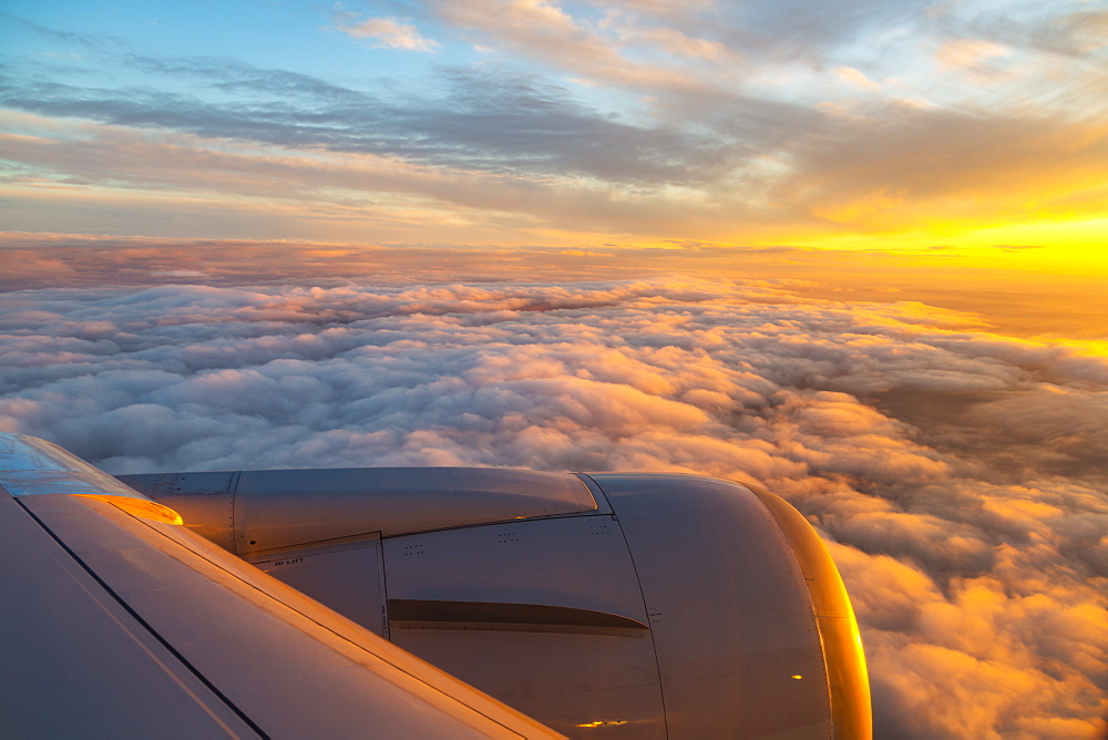 Generic view from airplane window of airplane wing and sunrise over England, United Kingdom, Europe