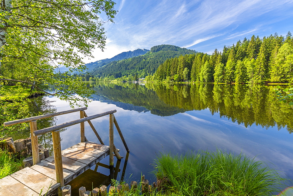 View of reflections in Schwarzsee, Kitzbuhel, Austrian Tyrol, Austria, Europe