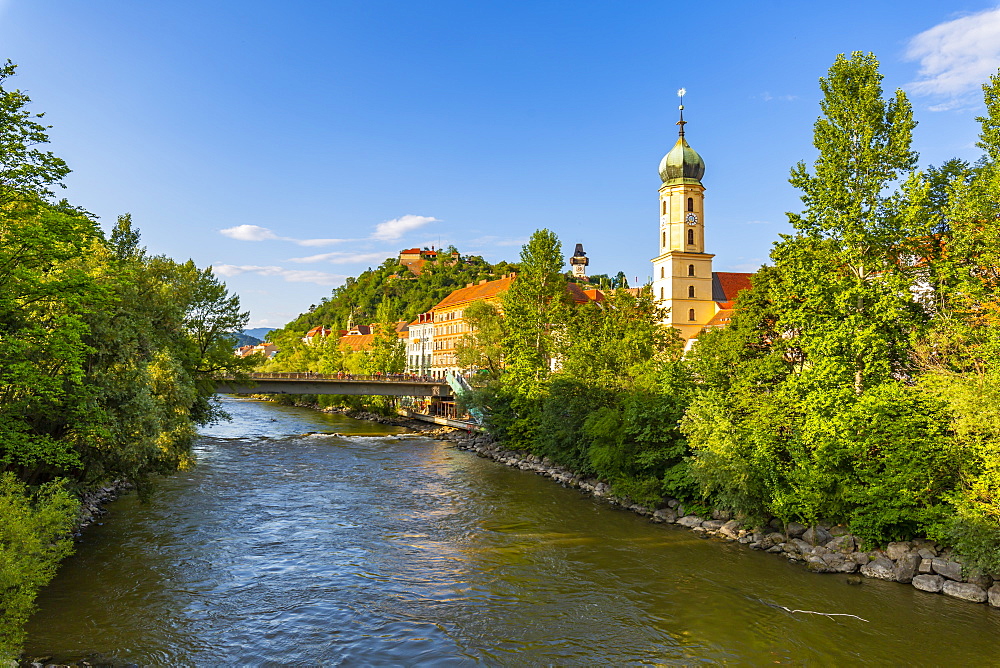 View of Mur River, Fanciscan Church and Castle (Schlossberg) overlooking the city, Graz, Styria, Austria, Europe