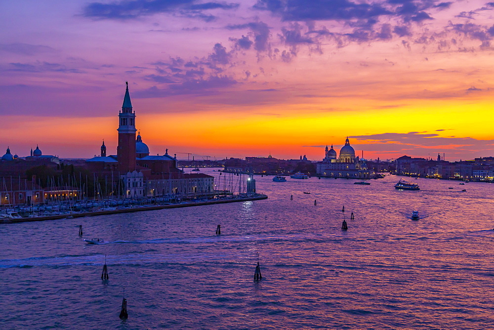 View of Venice skyline and red sky from cruise ship at dusk, Venice, UNESCO World Heritage Site, Veneto, Italy, Europe