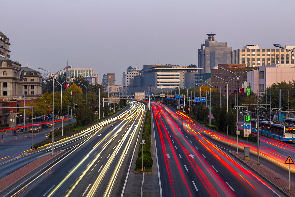 Traffic trail lights on major road near Beijing Zoo at dusk, Beijing, People's Republic of China, Asia