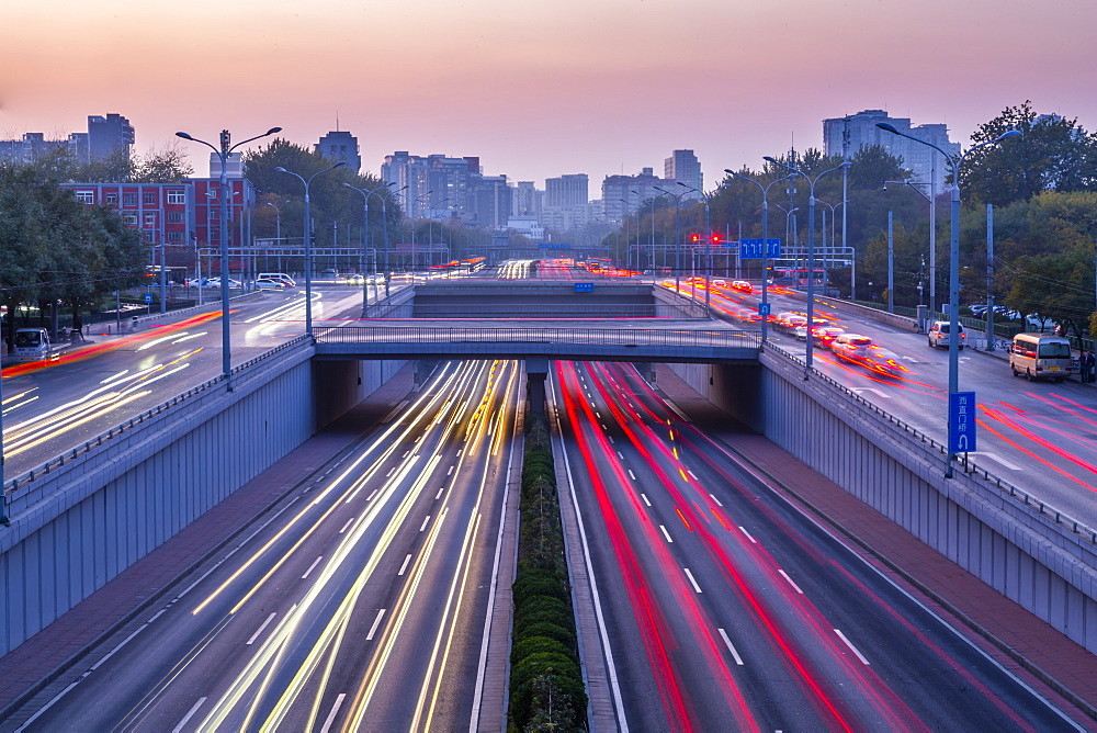 Traffic trail lights on major road near Beijing Zoo at dusk, Beijing, People's Republic of China, Asia