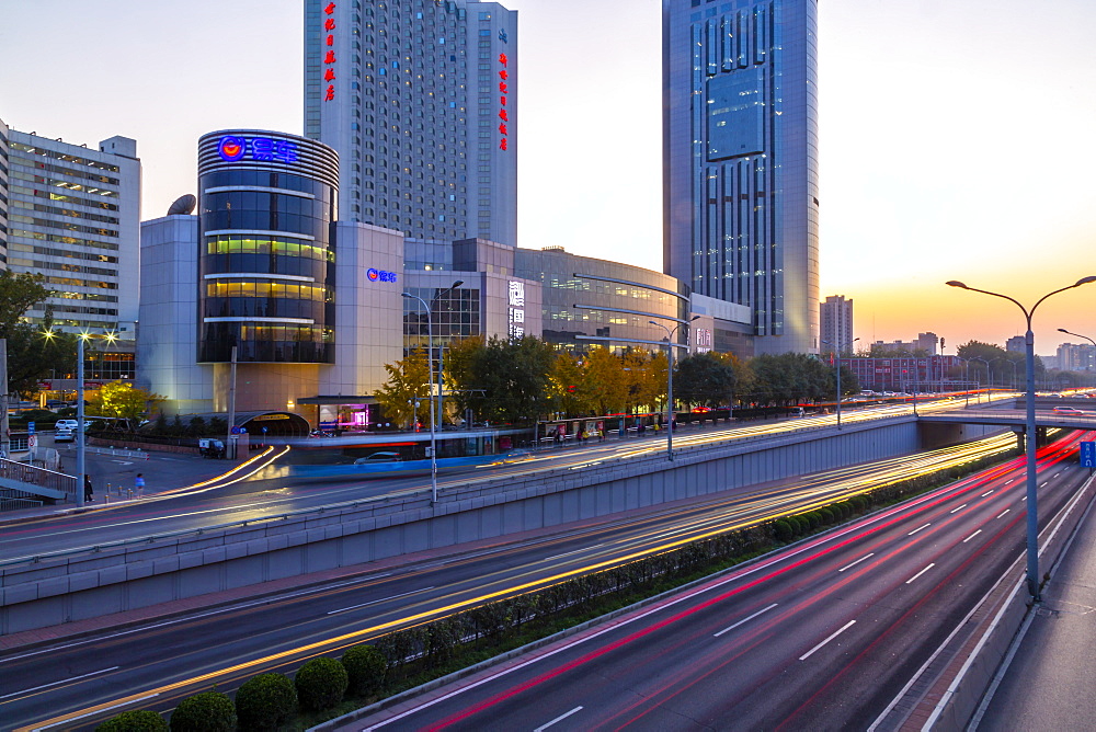 Traffic trail lights on major road near Beijing Zoo at dusk, Beijing, People's Republic of China, Asia