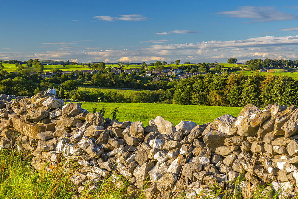 View of dry stone walls and Over Haddon village, Peak District National Park, Derbyshire, England, United Kingdom, Europe