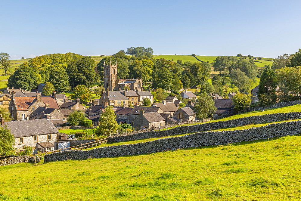 View of village church, cottages and dry stone walls, Hartington, Peak District National Park, Derbyshire, England, United Kingdom, Europe