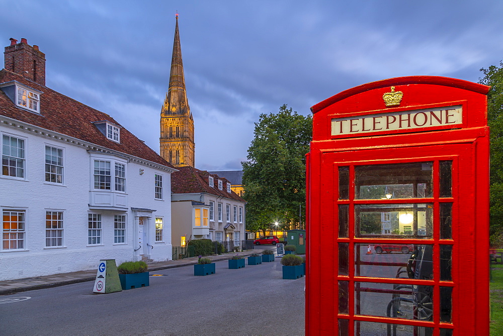 View of Salisbury Cathedral and red telephone box at dusk, Salisbury, Wiltshire, England, United Kingdom, Europe