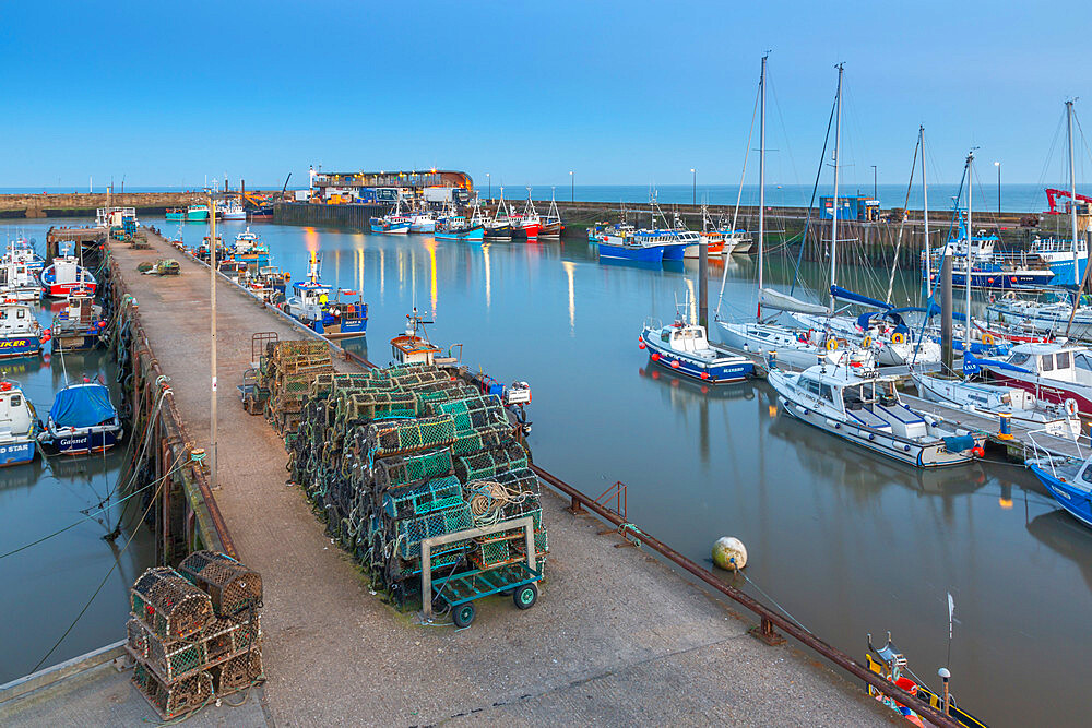 View of harbour boats in Bridlington Harbour at dusk, Bridlington, East Yorkshire, England, United Kingdom, Europe