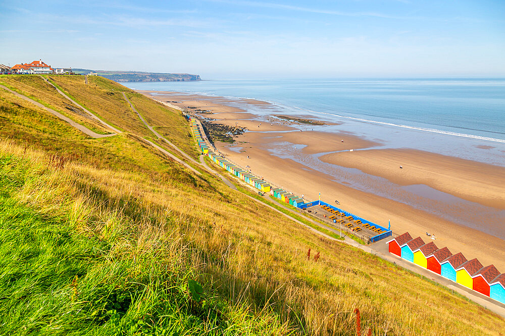 View of colourful beach huts on West Cliff Beach, Whitby, North Yorkshire, England, United Kingdom, Europe