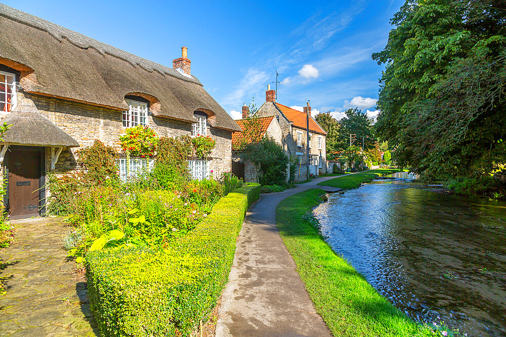 View of riverside cottages and Thornton Beck, Thornton Dale, North Yorkshire, England, United Kingdom, Europe