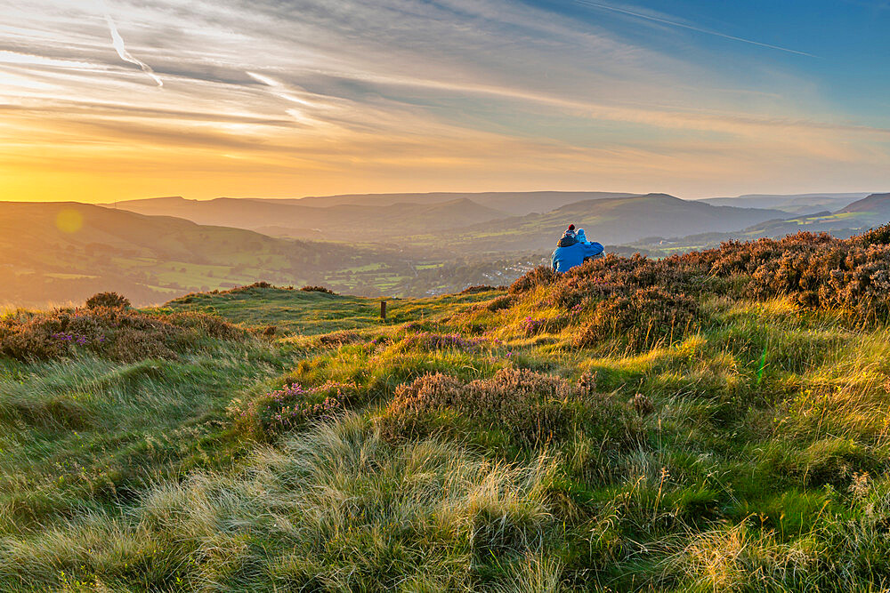 View of couple looking over Hathersage Booths from Millstone Edge, Derbyshire Peak District, Derbyshire, England, United Kingdom, Europe