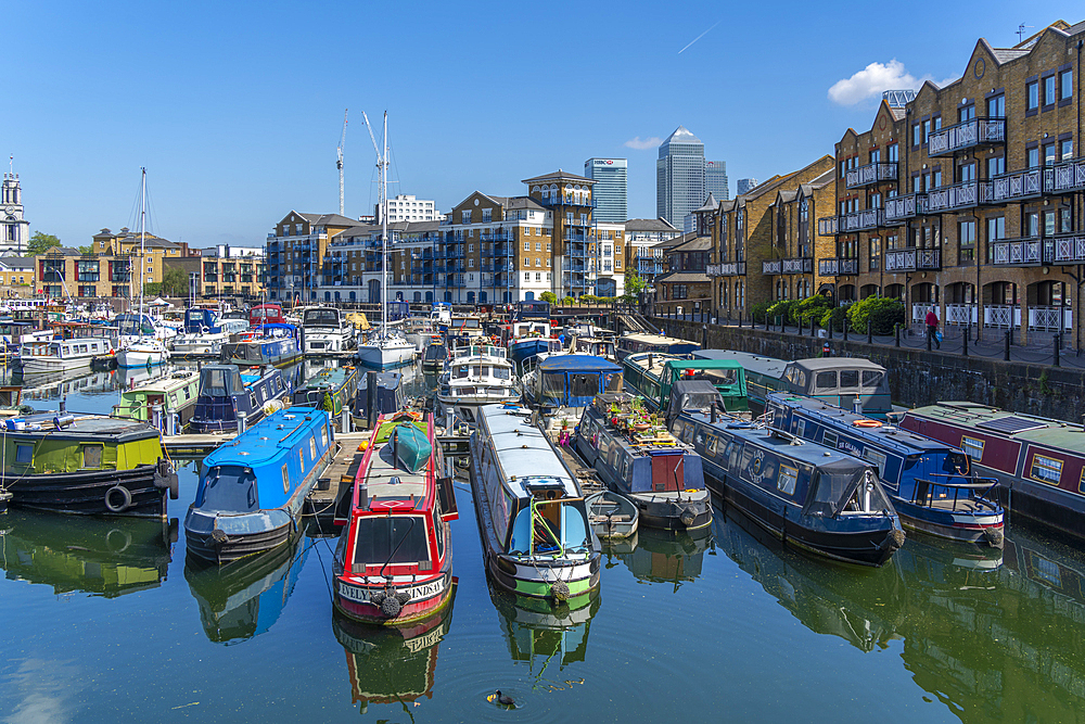 View of canal boats in the marina at the Limehouse Basin and Canary Wharf in background, Limehouse, London, England, United Kingdom, Europe