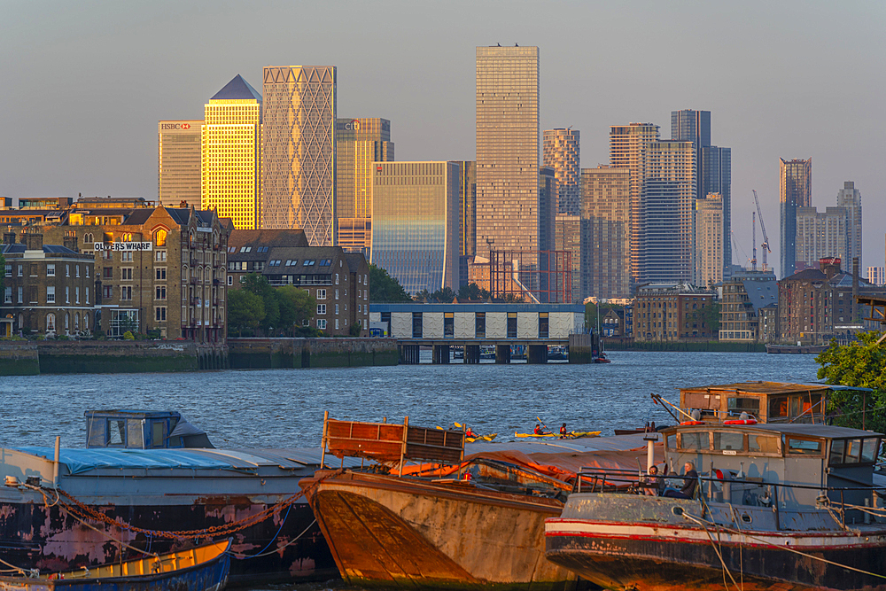 View of Thames barges, Docklands and Canary Wharf at sunset, London, England, United Kingdom, Europe